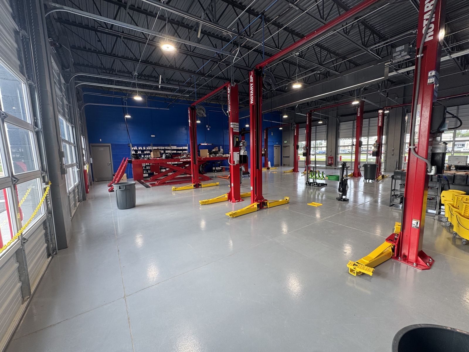 Auto service facility interior with cleaned floors and service bays after construction final clean