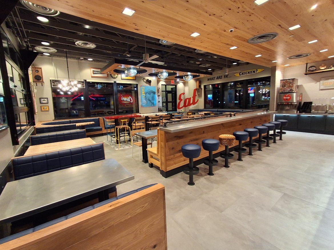 Quick-service restaurant dining room with cleaned floors, seating and counter after interior final clean