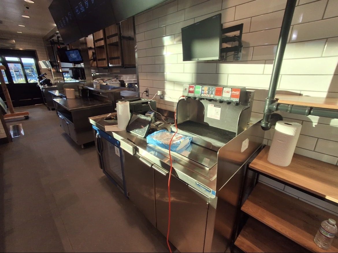 Quick-service restaurant beverage and service counter area during interior turnover